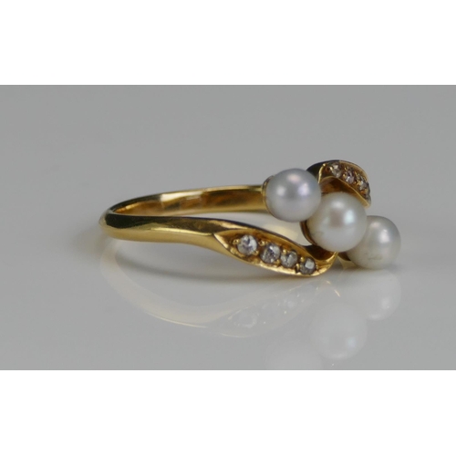 260 - A Cultured Pearl and Diamond Crossover Ring in a high carat precious yellow metal setting, 4.4mm lar... 