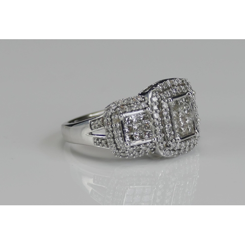 265 - An 18ct White Gold and Diamond Panel Ring, the central elements invisibly set princess cuts and enve... 