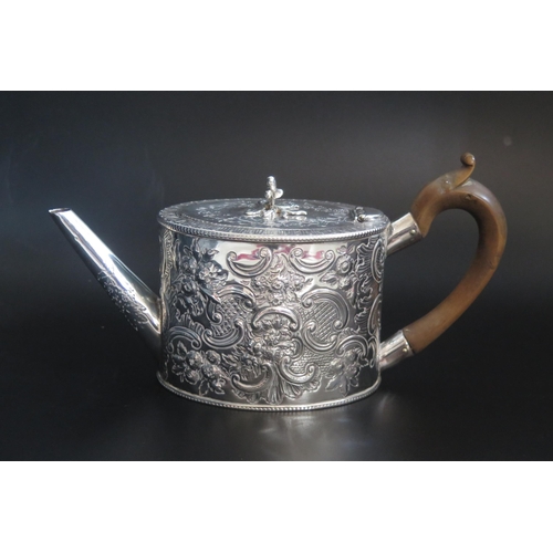 503 - A George III silver teapot, maker's mark worn, London, 1778, of oval form with repousse foliate and ... 