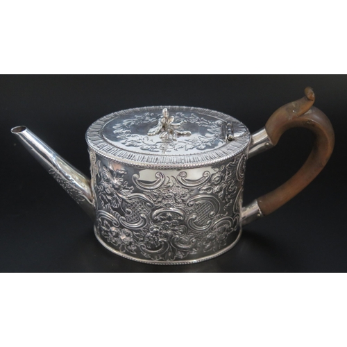 503 - A George III silver teapot, maker's mark worn, London, 1778, of oval form with repousse foliate and ... 