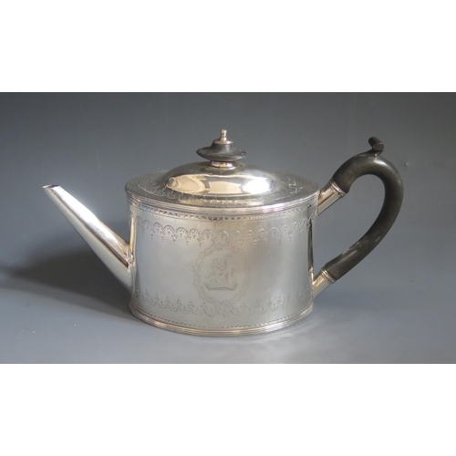 541 - A George III silver teapot, maker William Plummer, London, 1787, crested, of oval form with chased a... 