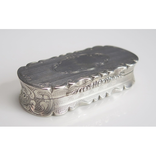 545 - A Victorian silver snuff box, maker Nathanial Mills, Birmingham 1857, of shaped oval outline, with c... 