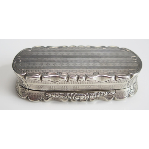 545 - A Victorian silver snuff box, maker Nathanial Mills, Birmingham 1857, of shaped oval outline, with c... 