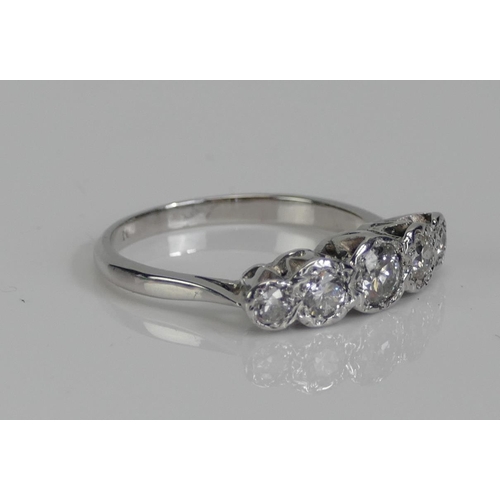 59 - A Diamond Five Stone Illusion Set Ring in a precious white metal setting (platinum or white gold), 4... 