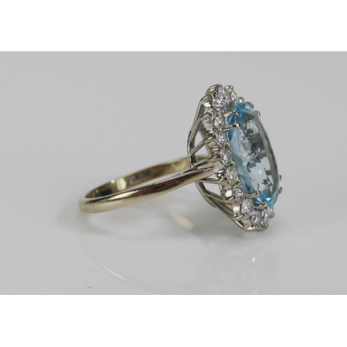 66 - An 18ct White Gold, Aqua Marine and Diamond Oval Cluster Ring, 13.8x9.3mm principal stone surrounded... 