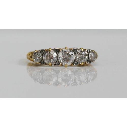 72 - An 18ct Gold and Diamond Five Stone Ring, c. 5.4mm principal brilliant round cut with 4.6 and 3.5mm ... 