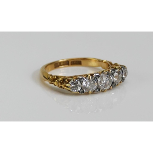 72 - An 18ct Gold and Diamond Five Stone Ring, c. 5.4mm principal brilliant round cut with 4.6 and 3.5mm ... 