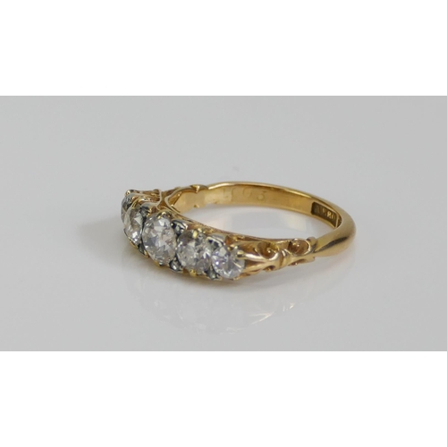 72 - An 18ct Gold and Diamond Five Stone Ring, c. 5.4mm principal brilliant round cut with 4.6 and 3.5mm ... 