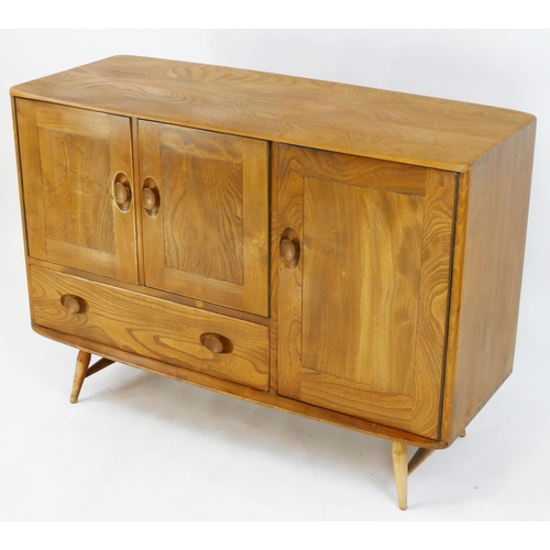 1459 - Ercol - elm and beech sideboard, fitted with cupboards and single drawer, enclosed by panelled doors... 