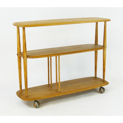 1461 - An elm and beech Ercol baby giraffe  bookcase/trolley, 91cm wide, 32cm deep, 72cm high.