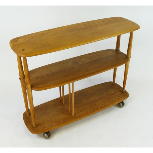 1461 - An elm and beech Ercol baby giraffe  bookcase/trolley, 91cm wide, 32cm deep, 72cm high.