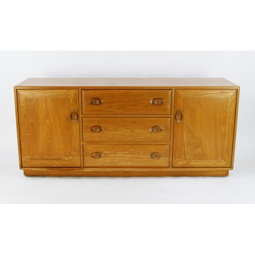 1464 - An elm and beech Ercol sideboard, containing three central drawers flanked by cupboard doors, on a p... 