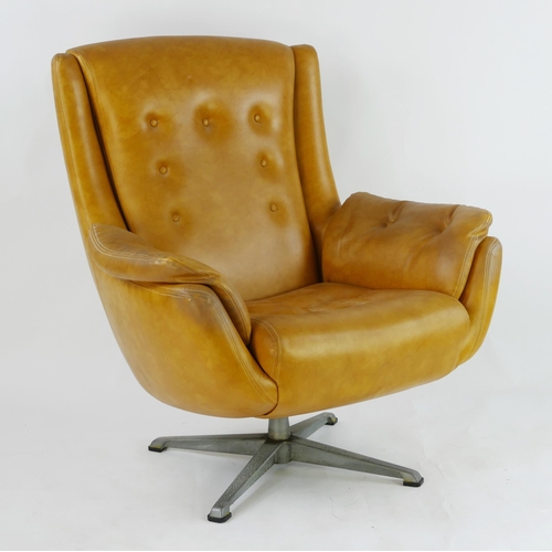 1465 - A tan fully upholstered swivel armchair in the Arne Jacobsen style.