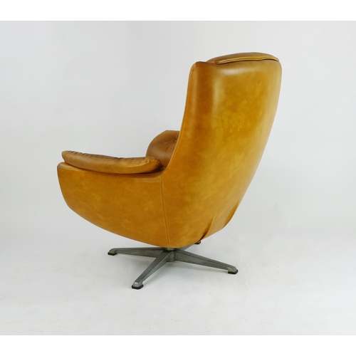 1465 - A tan fully upholstered swivel armchair in the Arne Jacobsen style.