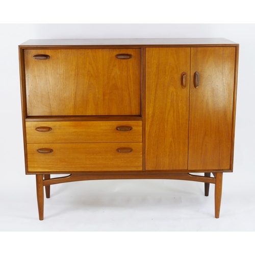 1474 - A G-Plan teak drinks cabinet/sideboard, by E Gomme, of rectangular outline, containing a fall front ... 