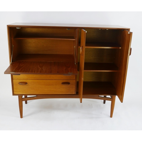 1474 - A G-Plan teak drinks cabinet/sideboard, by E Gomme, of rectangular outline, containing a fall front ... 