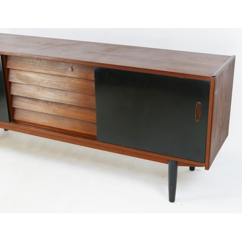 1475 - A 1960's teak sideboard, containing five short drawers, flanked by two sliding doors, on turned and ... 