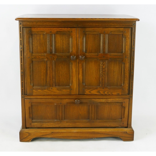 1481 - A modern oak television cabinet of panelled construction with two panelled cupboard doors and single... 