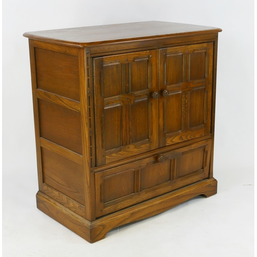 1481 - A modern oak television cabinet of panelled construction with two panelled cupboard doors and single... 