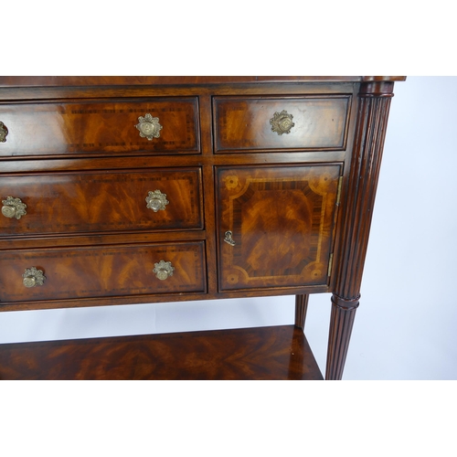 1487 - A Theodore Alexander mahogany and crossbanded sideboard, with rectangular top with three central sho... 