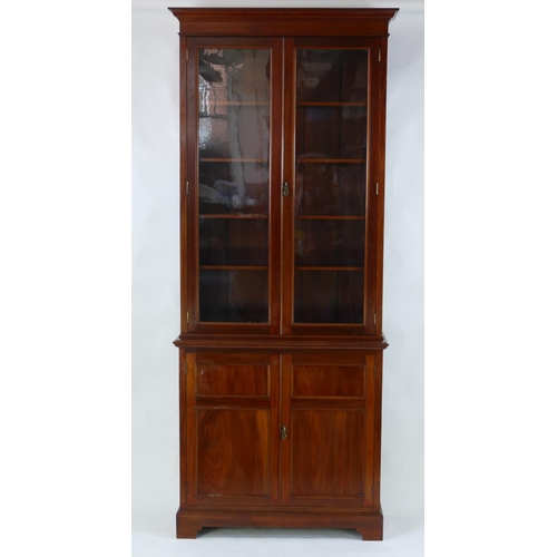 1494 - A Victorian mahogany bookcase, the upper part with a pair of glazed panelled doors enclosing shelvin... 