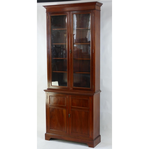 1494 - A Victorian mahogany bookcase, the upper part with a pair of glazed panelled doors enclosing shelvin... 