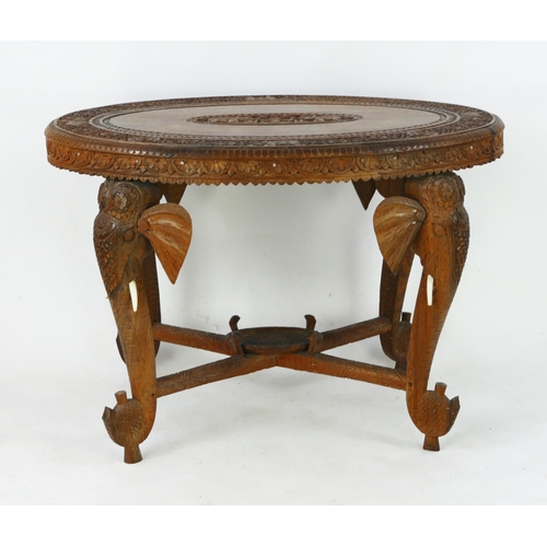 1496 - An Indo-colonial oval  carved hardwood occasional table, with carved foliate border, with legs in th... 