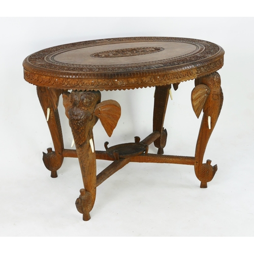 1496 - An Indo-colonial oval  carved hardwood occasional table, with carved foliate border, with legs in th... 