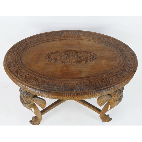 1496 - An Indo-colonial oval  carved hardwood occasional table, with carved foliate border, with legs in th... 