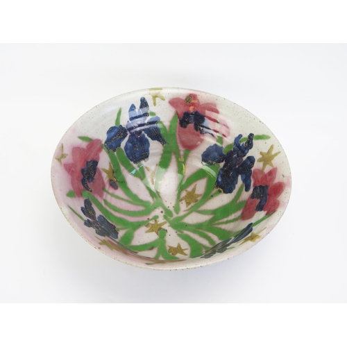 1502 - A large studio pottery bowl, with variegated decorated exterior, and Iris decorated interior, 33cm d... 