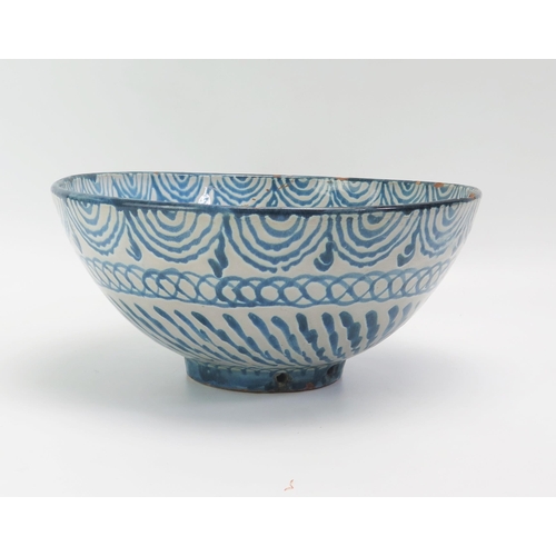 1522 - A Spanish pottery fruit bowl, with banded blue scroll and foliate decoration 26.5cm diameter,