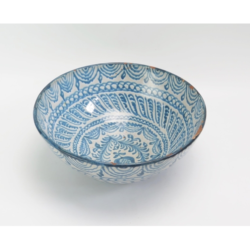 1522 - A Spanish pottery fruit bowl, with banded blue scroll and foliate decoration 26.5cm diameter,