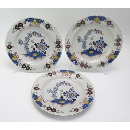 1526 - Three tin glazed earthenware plates in the 18th century Dutch style 22.5cm diameter.