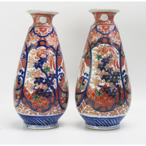 1531 - A pair of Imari porcelain vases of ovoid form, with panels of exotic birds and foliage, in tradition... 