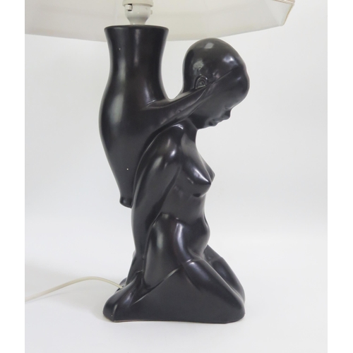 1545 - A Dartmouth pottery table lamp in the form of a kneeling African female.