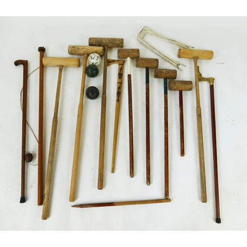 1556 - A collection of assorted croquet mallets, balls  and  steel hoops