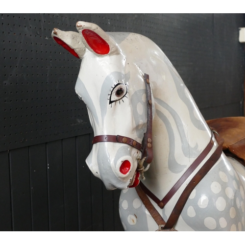 1563 - A large late Victorian repainted dappled rocking horse, with pricked ears, glass eyes, flared nostri... 