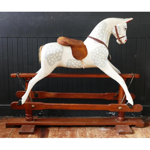 1563 - A large late Victorian repainted dappled rocking horse, with pricked ears, glass eyes, flared nostri... 