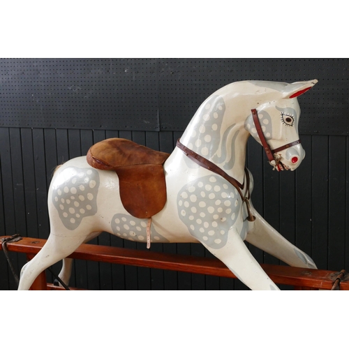 1563 - A large late Victorian repainted dappled rocking horse, with pricked ears, glass eyes, flared nostri... 