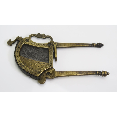 1567 - An Indo-Persian brass and steel betel nut cutter, of traditional design,