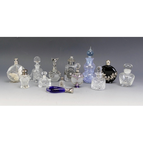 1603A - A collection of clear glass and gilt decorated scent bottles, including metal mounted scent bottles,... 