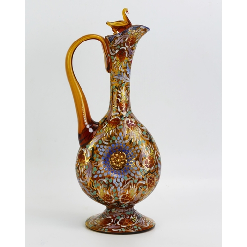 1604 - A continental amber glass ewer and stopper, with enamel polychrome floral decoration the stopper sur... 