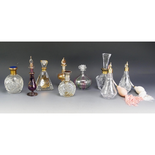 1604A - A collection of clear glass and gilt decorated scent bottles, atomisers, of various shapes and sizes... 