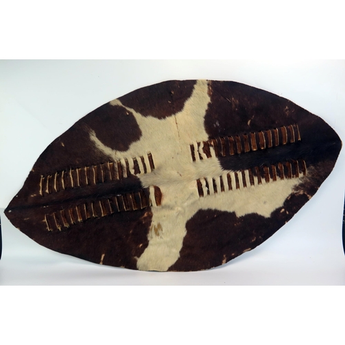 1624 - A Zulu hide shield, of traditional oval design with two rows or vertical stripes, 106cm x 60cm.