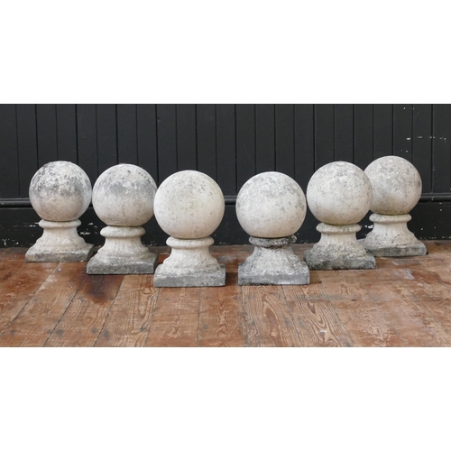 1663 - A set of six reconstituted stone ball finials, mounted on square bases, 32cm high. (6).