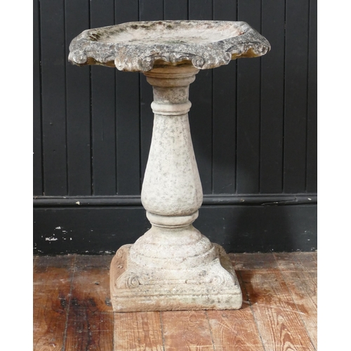 1668 - A reconstituted stone bird bath, with circular dished top, raised on a knopped baluster column and s... 