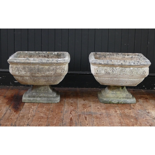 1669 - A pair of reconstituted stone urns of square tapering outline, with banded floral decoration, raised... 