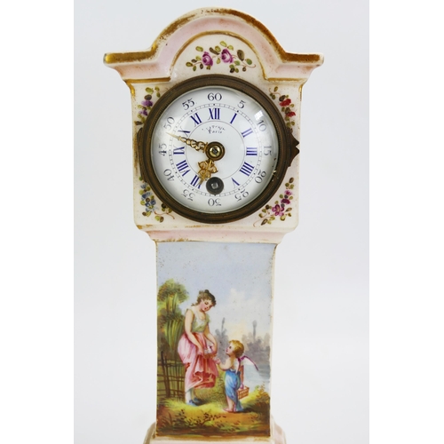 1677 - A continental porcelain model of a long case clock, with 6cm dial , the case with floral decoration,... 