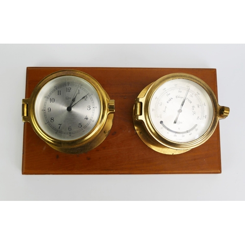 1678 - A ships brass cased bulk head timepiece, and a brass cased barometer mounted on a polished wood plaq... 