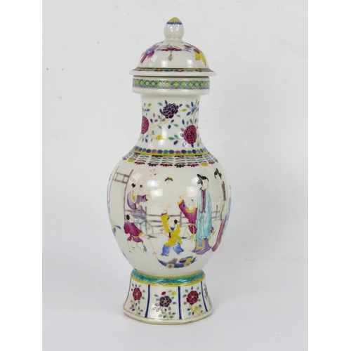 1697 - A Chinese famille rose vase and cover, of baluster form decorated in enamels depicting figures in a ... 